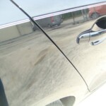 Before and after photographs of a damaged black Volkswagon Jetta that was repaired by Elite Paint & Body Shop in West Palm Beach, Florida.